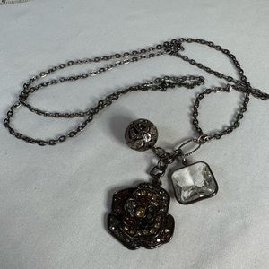Long flower and dangling orb charm style necklace
